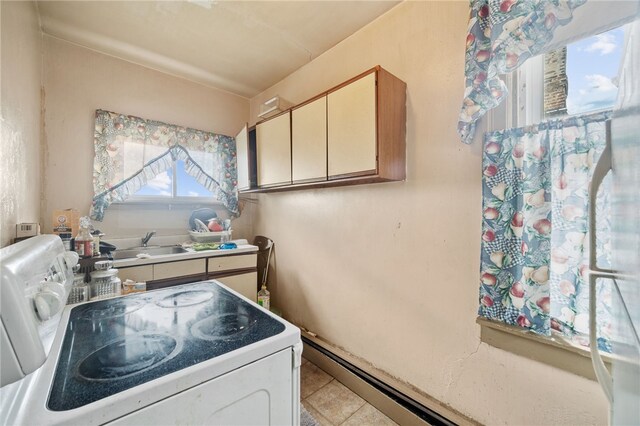 kitchen with sink, light tile patterned flooring, and stove