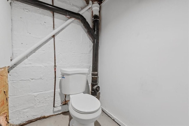 bathroom featuring toilet and concrete flooring