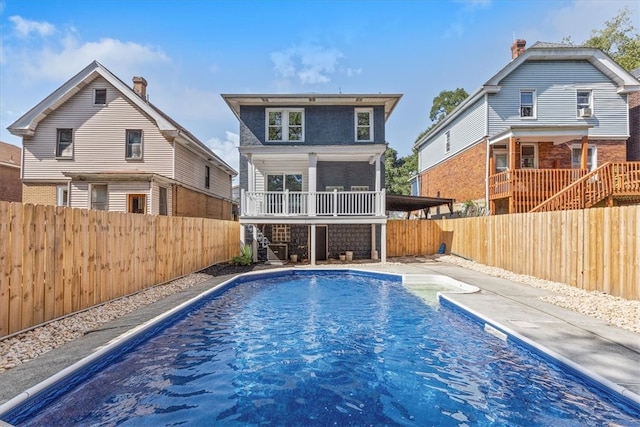 back of house featuring a fenced in pool