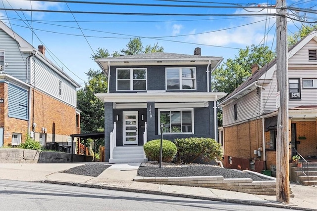 american foursquare style home with a chimney