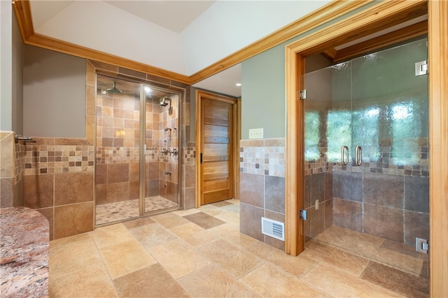 bathroom with tile patterned floors, walk in shower, and ornamental molding