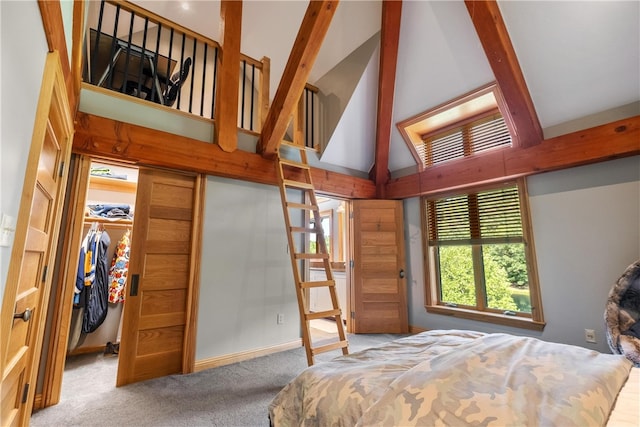 bedroom with a closet, high vaulted ceiling, and light colored carpet