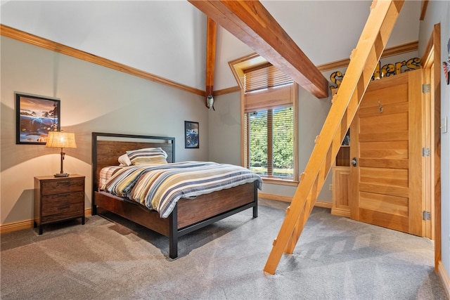 carpeted bedroom with vaulted ceiling with beams and ornamental molding