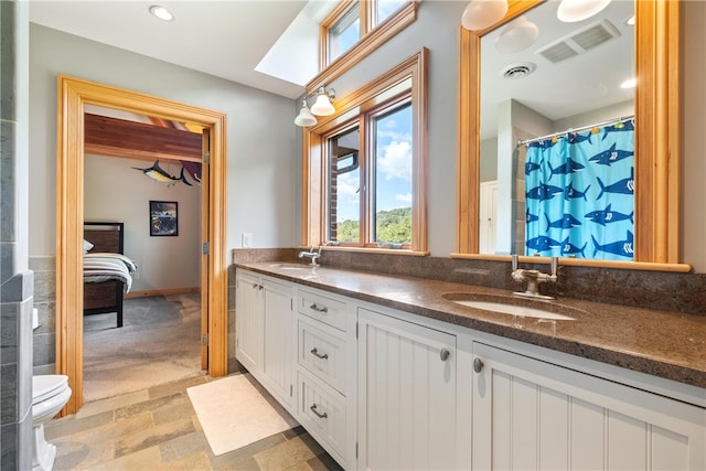 bathroom with tile patterned flooring, vanity, and toilet