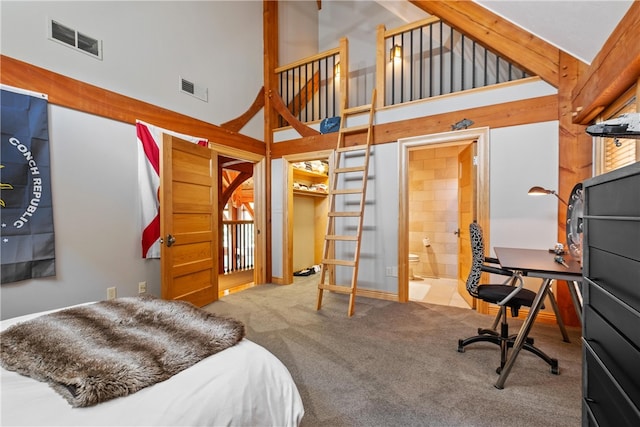 bedroom with carpet floors, high vaulted ceiling, ensuite bathroom, and beamed ceiling