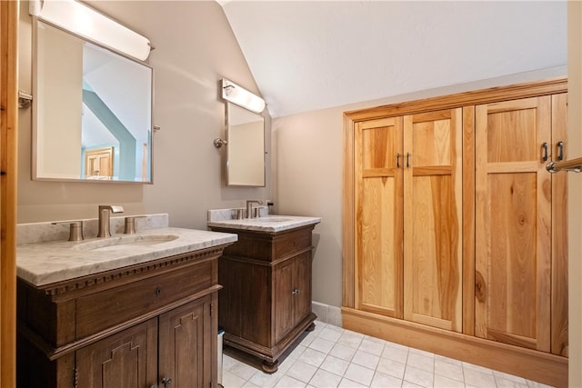 bathroom featuring lofted ceiling, vanity, and tile patterned floors