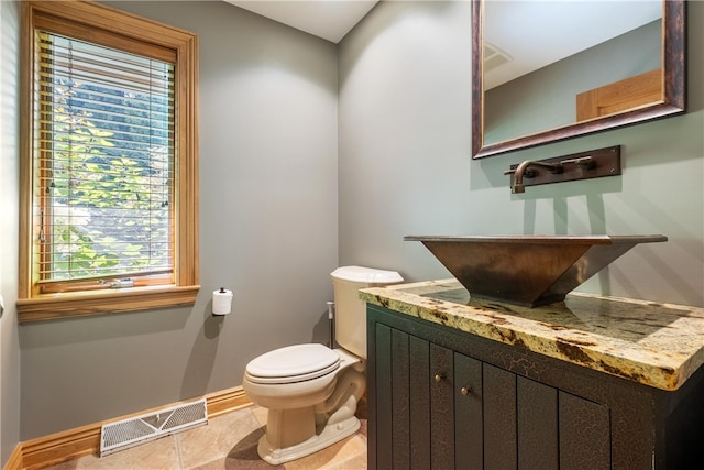 bathroom featuring tile patterned floors, plenty of natural light, vanity, and toilet