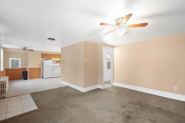 unfurnished living room featuring light tile patterned floors and ceiling fan