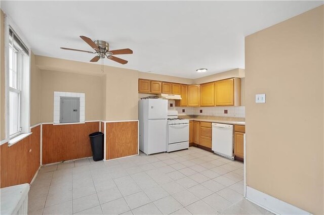 kitchen featuring ceiling fan, light tile patterned flooring, a healthy amount of sunlight, and white appliances