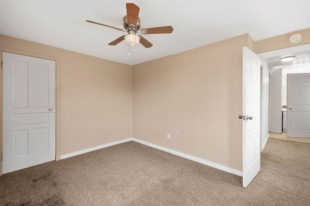 unfurnished bedroom with ceiling fan and light carpet