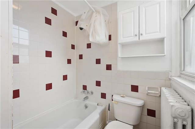 bathroom with shower / bath combination with curtain, toilet, tile walls, and radiator