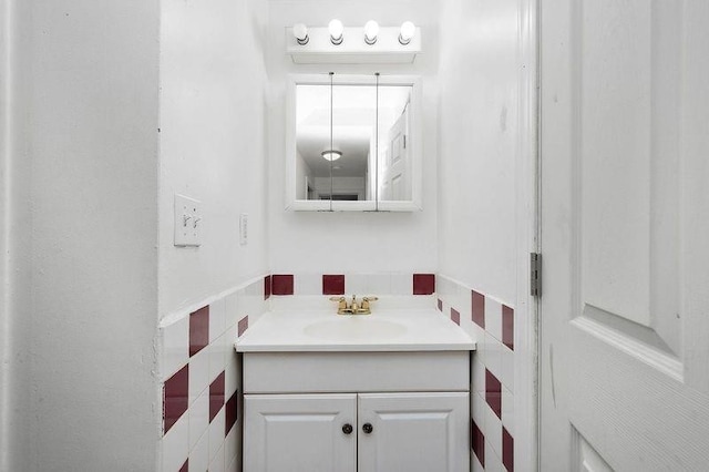 bathroom with tile walls and vanity