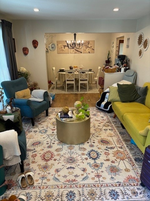 living room with hardwood / wood-style flooring and a notable chandelier