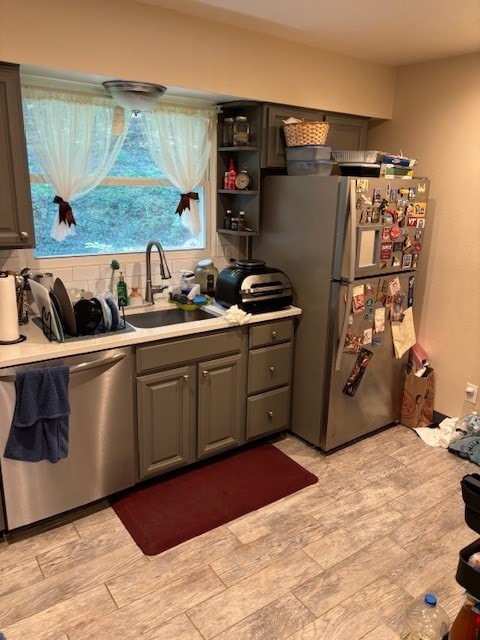 kitchen with sink, stainless steel appliances, and gray cabinets