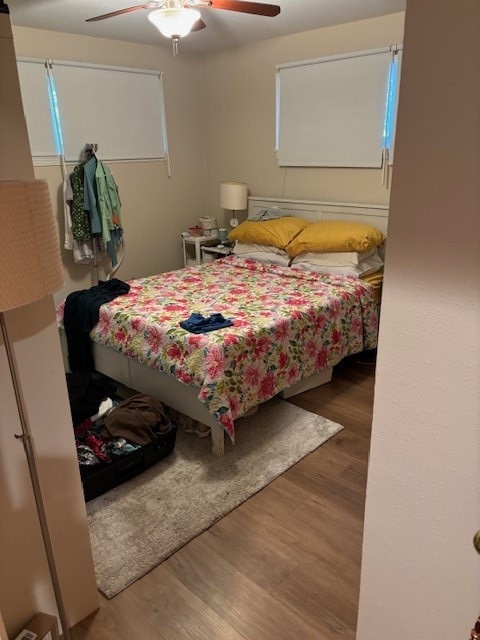 bedroom with ceiling fan and wood-type flooring