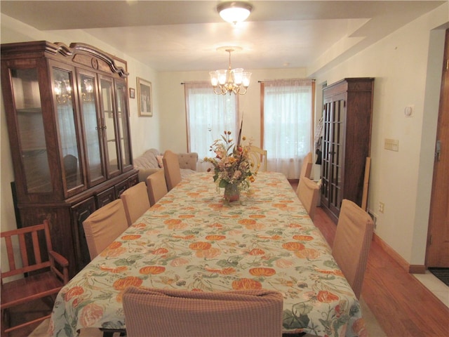 dining space with an inviting chandelier