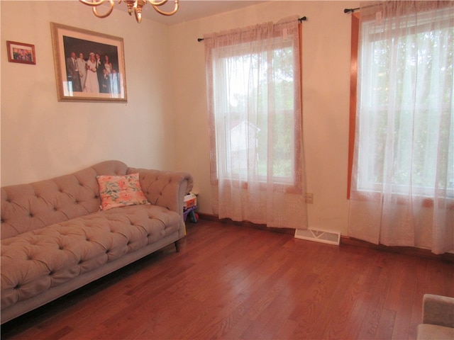 living room featuring hardwood / wood-style flooring and a notable chandelier