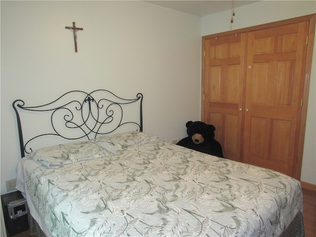 bedroom with a closet and hardwood / wood-style flooring