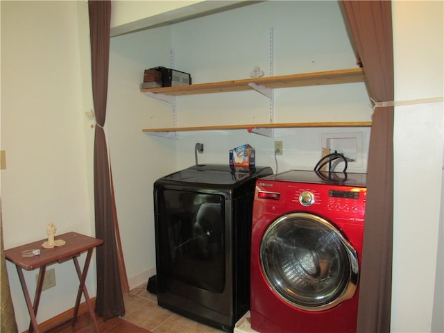 laundry room featuring light tile patterned floors and washer and clothes dryer