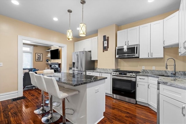 3943 Perrysville Ave, Observatory Hill, PA 15214 - kitchen with dark wood-type flooring, white cabinets, appliances with stainless steel finishes, and a sink