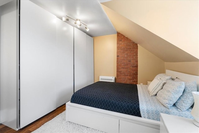 3943 Perrysville Ave, Observatory Hill, PA 15214 - bedroom featuring dark wood finished floors, an AC wall unit, and vaulted ceiling