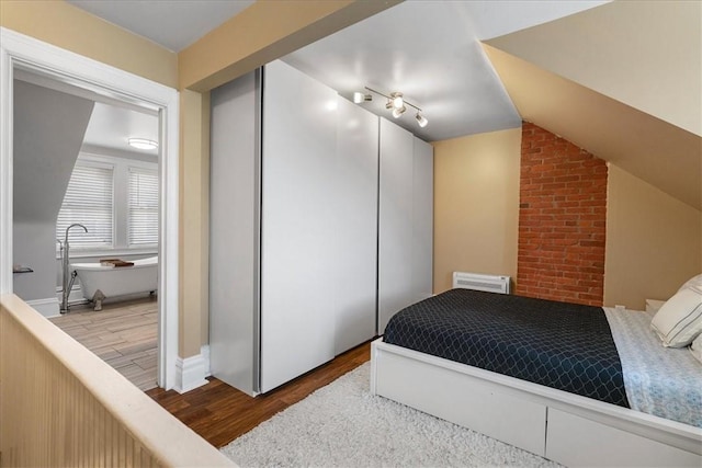 3943 Perrysville Ave, Observatory Hill, PA 15214 - bedroom featuring vaulted ceiling, wood finished floors, a closet, and track lighting