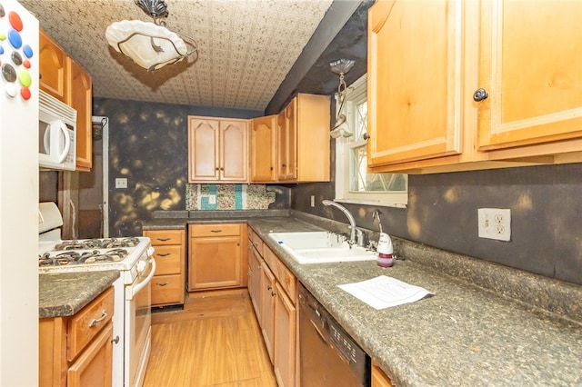 kitchen featuring sink, light wood-type flooring, tasteful backsplash, and white appliances