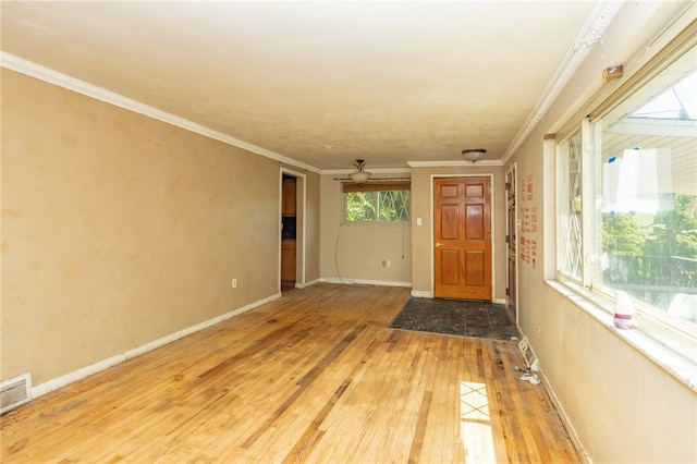 spare room with ceiling fan, light hardwood / wood-style floors, and ornamental molding