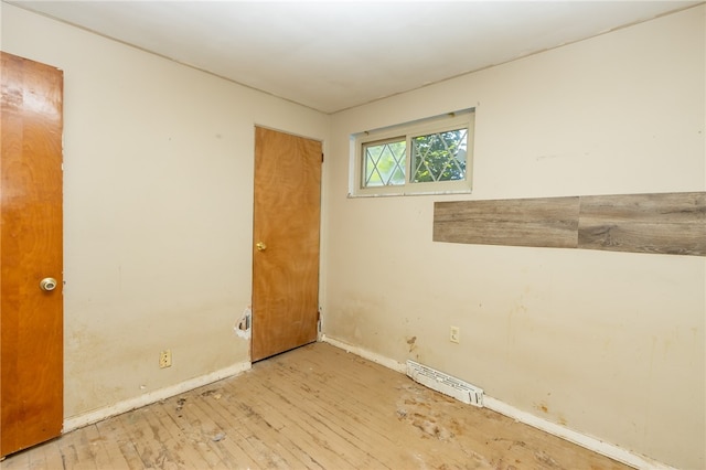 unfurnished room with light wood-type flooring