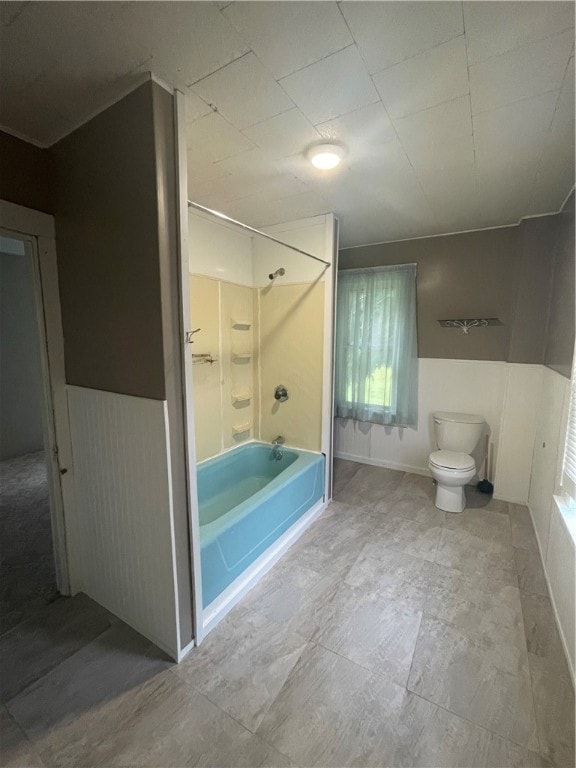 bathroom featuring bathing tub / shower combination, toilet, and tile patterned floors