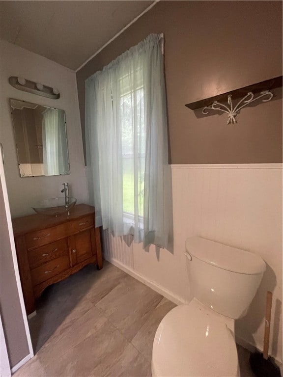 bathroom featuring tile patterned flooring, toilet, and vanity