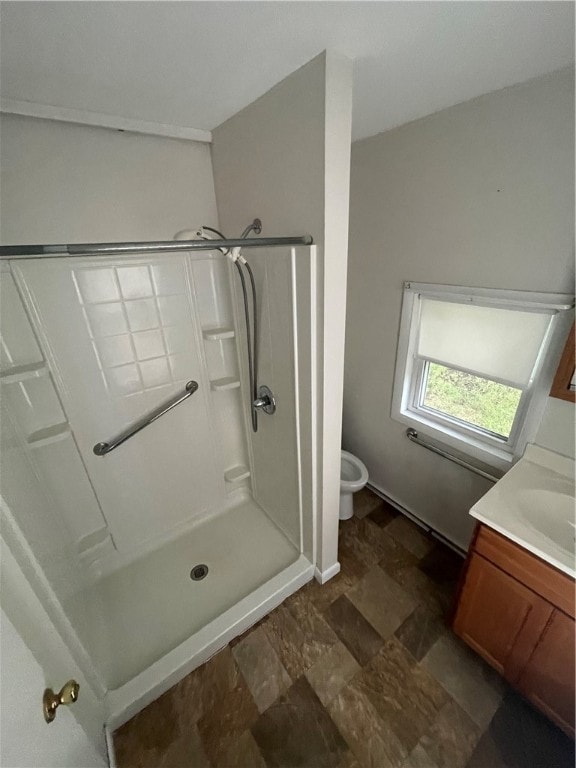 bathroom featuring tile patterned floors, vanity, walk in shower, and toilet