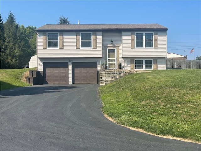 bi-level home with a front yard and a garage