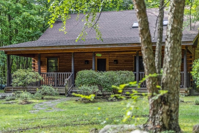 log home featuring a front lawn and a porch