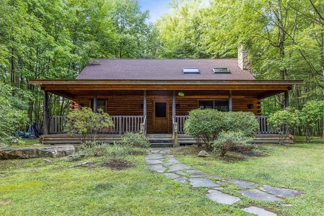 00 Alexander Rd, Brady Twp But, PA 16057 - log cabin with covered porch, a chimney, log exterior, a front lawn, and a shingled roof