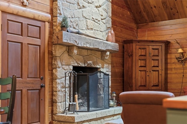 unfurnished living room with lofted ceiling, wooden ceiling, and a stone fireplace