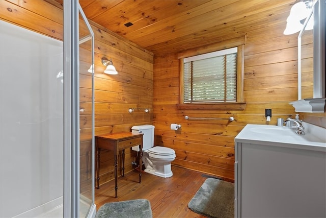 bathroom featuring hardwood / wood-style floors, vanity, wooden walls, wood ceiling, and toilet