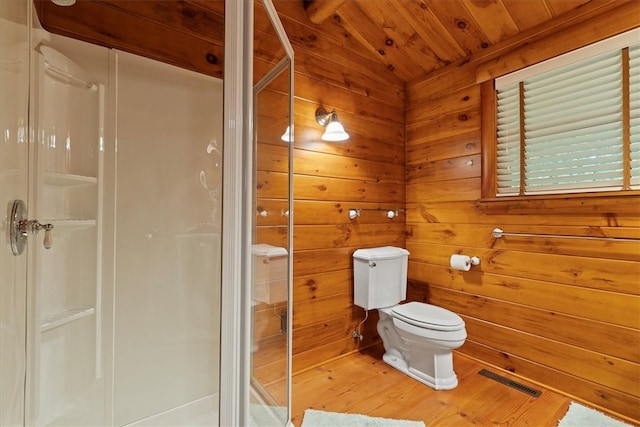 bathroom featuring toilet, wood walls, hardwood / wood-style floors, wooden ceiling, and walk in shower