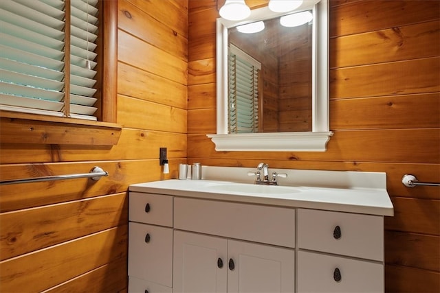 bathroom featuring wooden walls and vanity