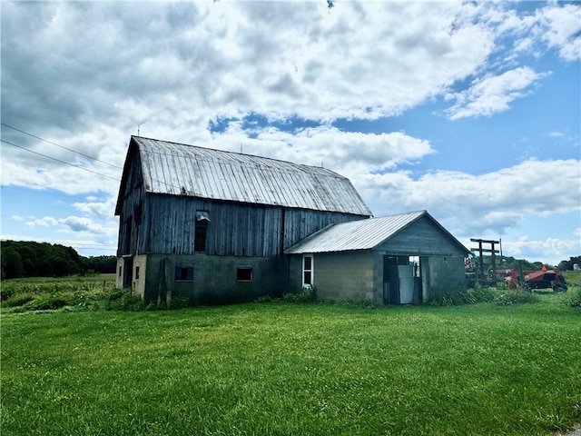 back of property featuring a lawn