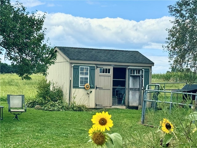 view of outbuilding featuring a lawn