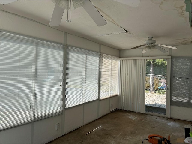 unfurnished sunroom with ceiling fan