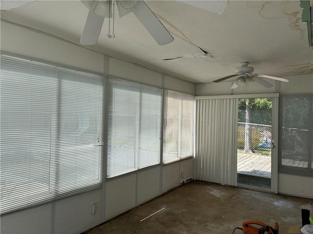 unfurnished sunroom with plenty of natural light and ceiling fan