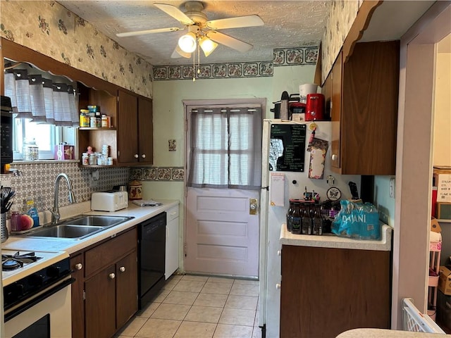 kitchen with a sink, range with gas cooktop, dishwasher, and light countertops