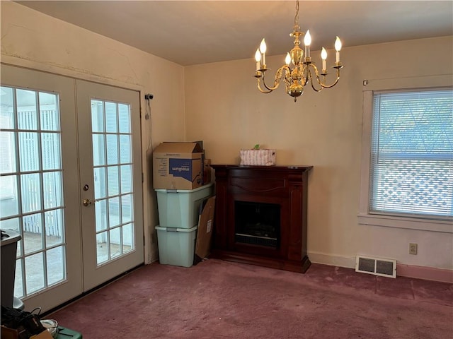 interior space with visible vents, carpet floors, and french doors