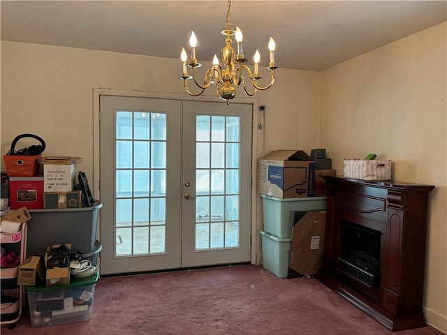 doorway to outside with a wealth of natural light, french doors, a fireplace, and carpet flooring