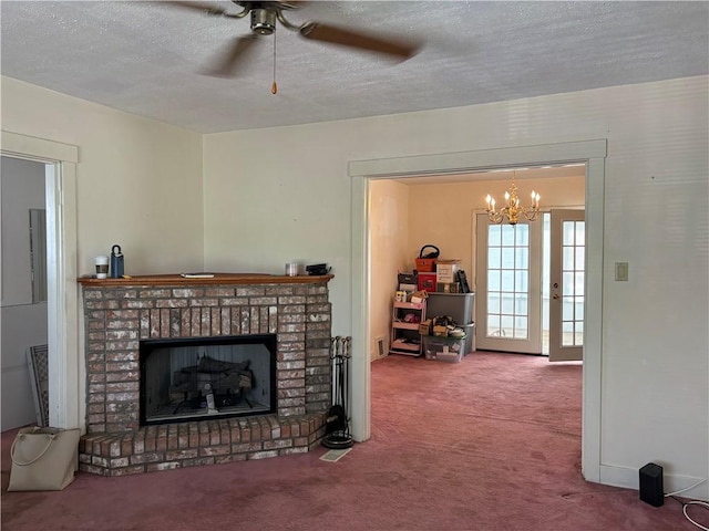 carpeted living room featuring a ceiling fan, a fireplace, and a textured ceiling