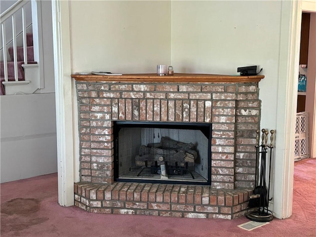 details with carpet and a brick fireplace