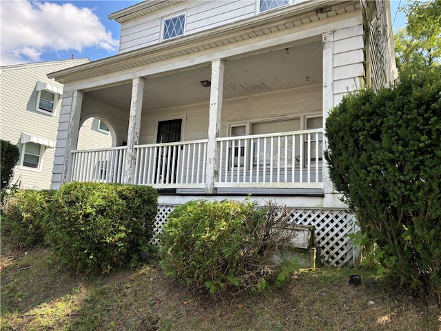 view of property exterior with a porch