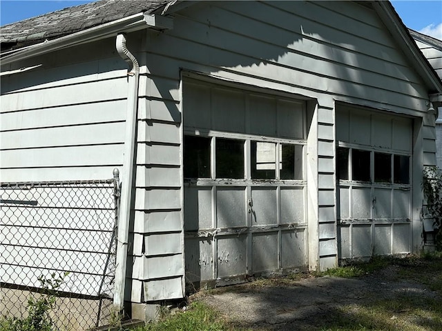 view of side of property with an outdoor structure and fence